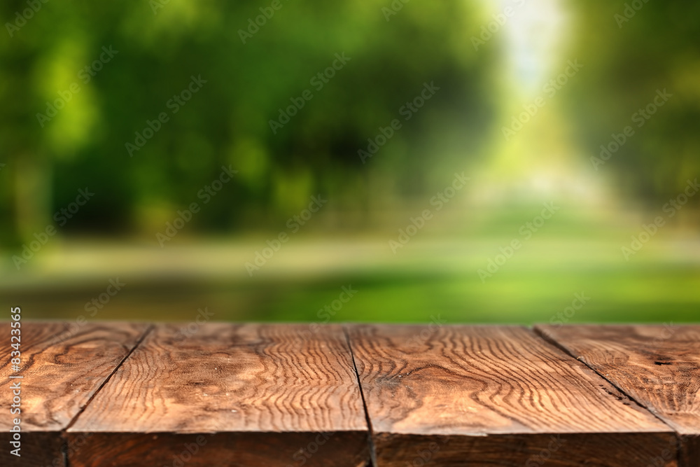 Empty wooden table with city park on background Empty wooden table with city park on background