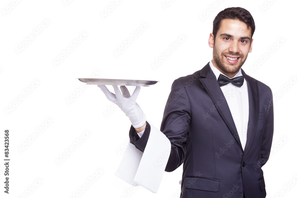 Smiling waiter holding an empty silver tray, isolated on white b Smiling waiter holding an empty silver tray, isolated on white b