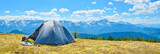 Panoramic view of tourist tent and a mountain range