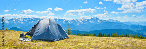 Panoramic view of tourist tent and a mountain range