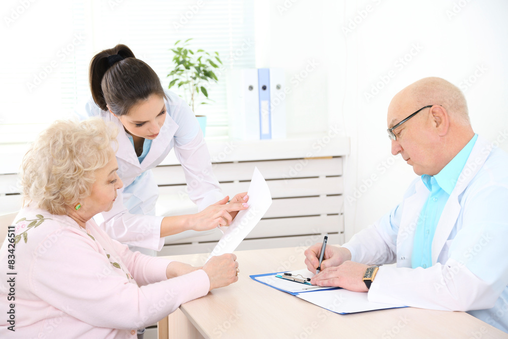 Happy doctors and patient in hospital clinic Happy doctors and patient in hospital clinic