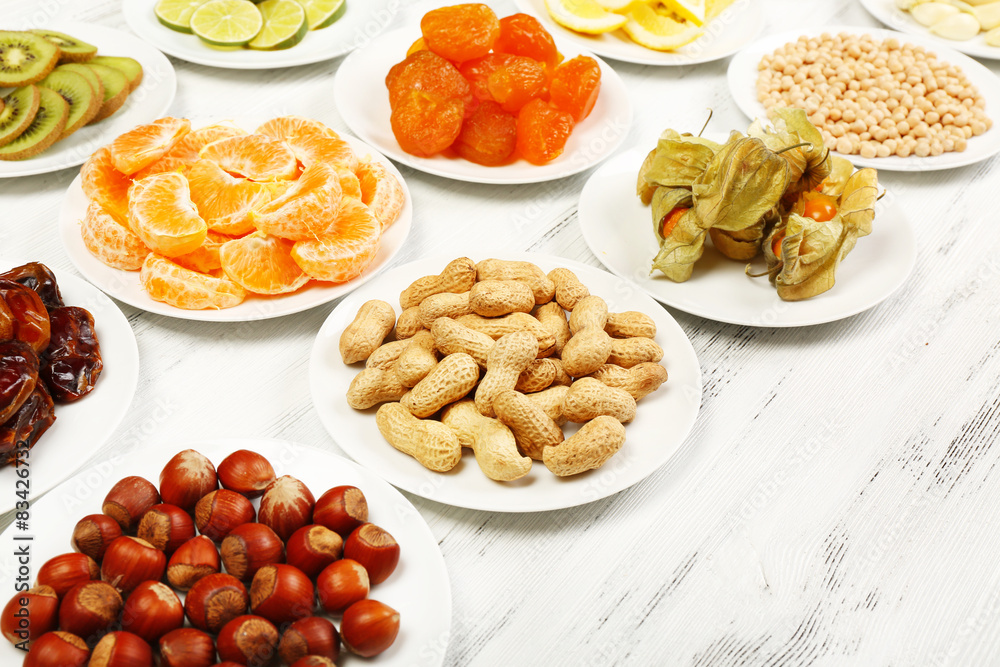 Different products on saucers on wooden table, closeup Different products on saucers on wooden table, closeup