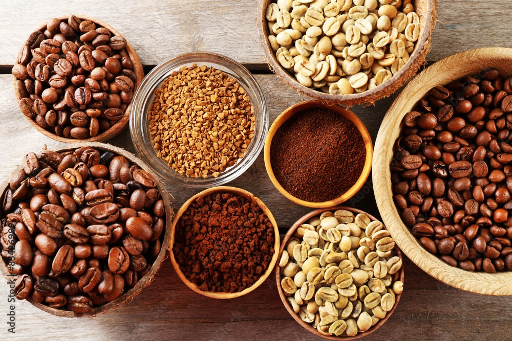 Various of coffee in small dishes on wooden table, top view Various of coffee in small dishes on wooden table, top view