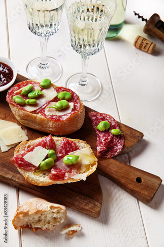 Italian snacks. salami sandwich with parmesan cheese & broad bea