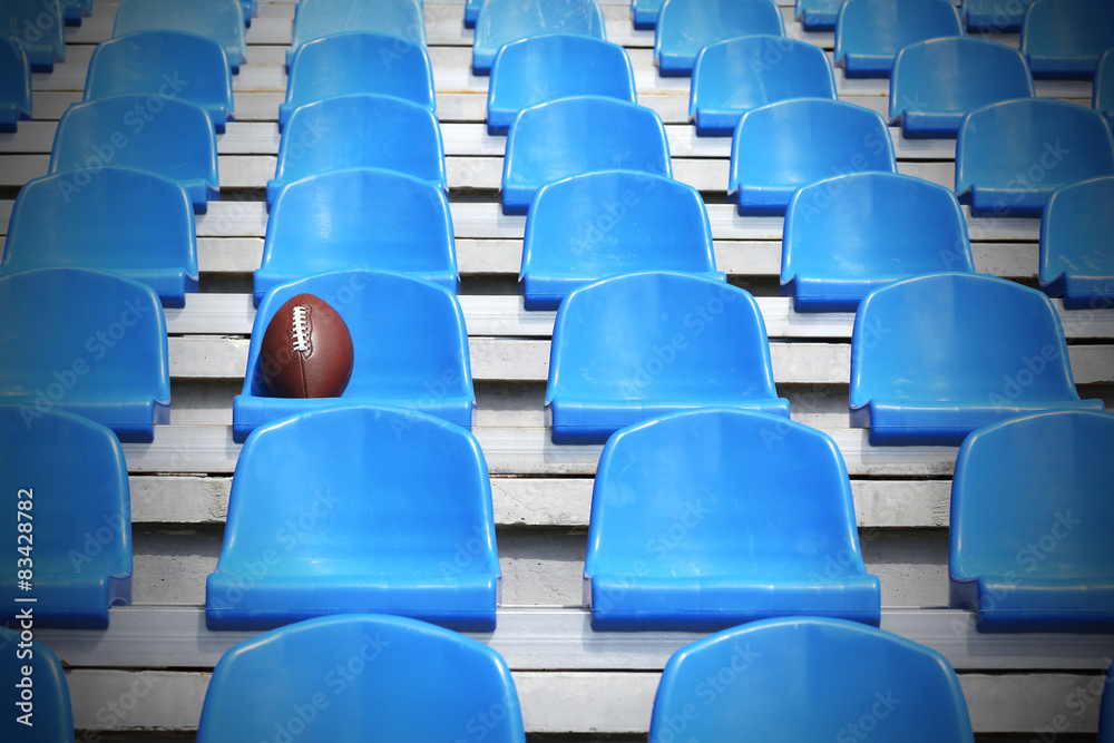 Naklejka premium Rugby ball on stadium seat