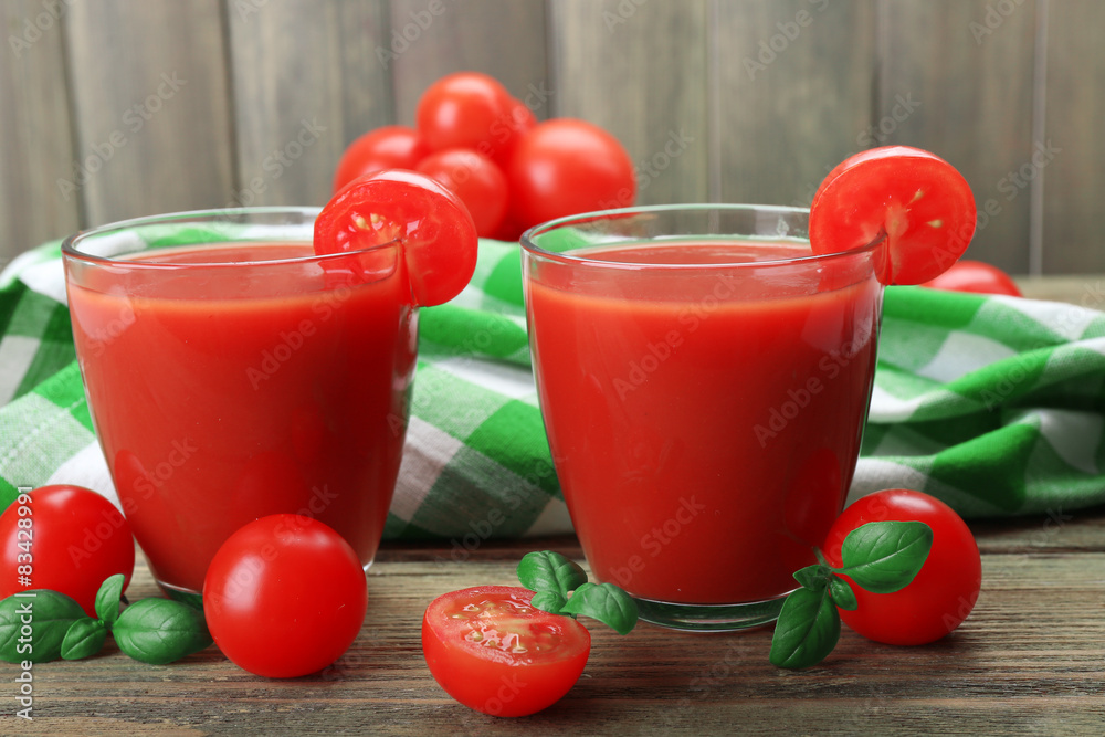 Glasses of tomato juice with vegetables on table close up Glasses of tomato juice with vegetables on table close up