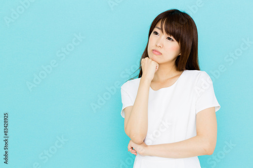 attractive asian nurse on blue background © taka