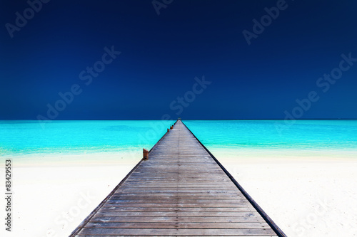 Wooden long jetty over lagoon with amazing clean water © Martin Valigursky