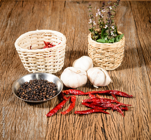  herbs, spices and and pepper, on wooden background