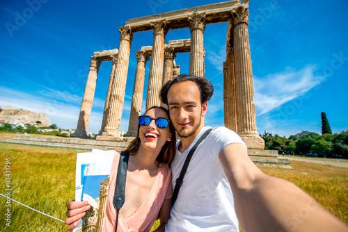 Young couple taking selfie picture with Zeus temple on photo