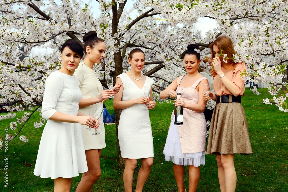 Girls with champagne celebrating in sakura's garden. Girls with champagne celebrating in sakura's garden.