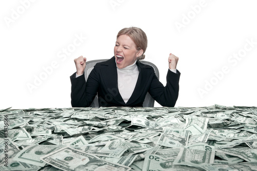 portrait of young woman sitting behind the table full of cash photo