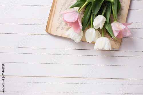 Fototapeta Naklejka Na Ścianę i Meble -  Background with fresh  tulip flowers on  vintage book