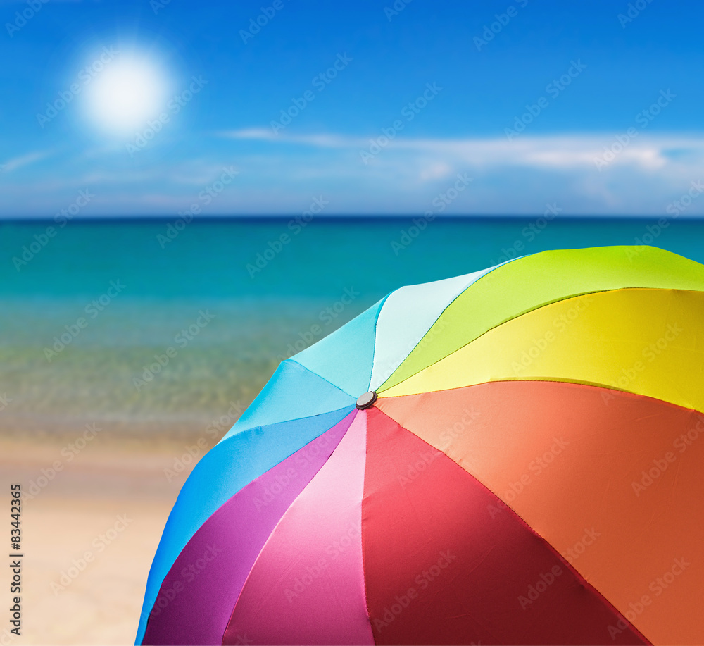 colorful umbrella on the beach background