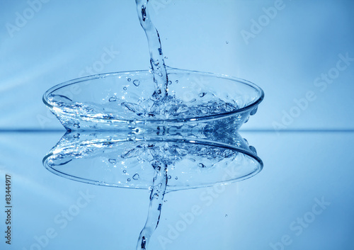 Water splashing from glass isolated on white background. Manipul