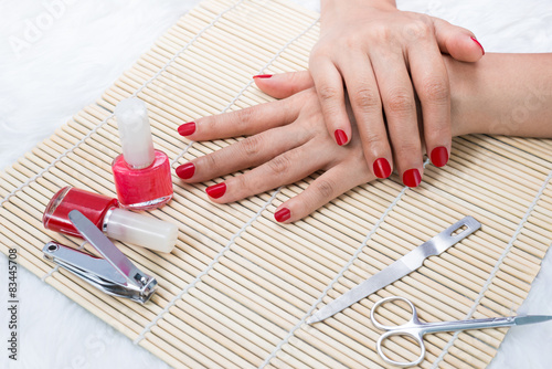 Beautiful manicured woman s nails with red nail polish