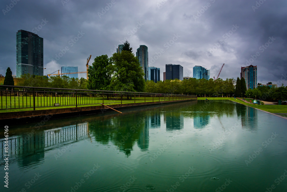 The skyline reflecting in a pond, at Downtown Park, in Bellevue,