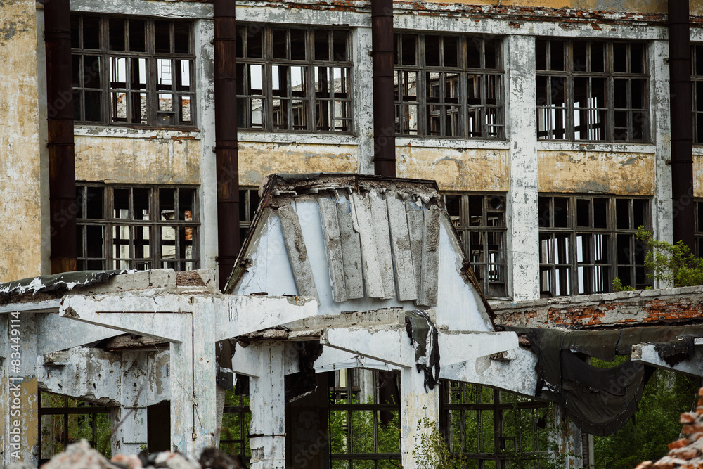 A ruined building of a plant with a row of empty windows A ruined building of a plant with a row of empty windows