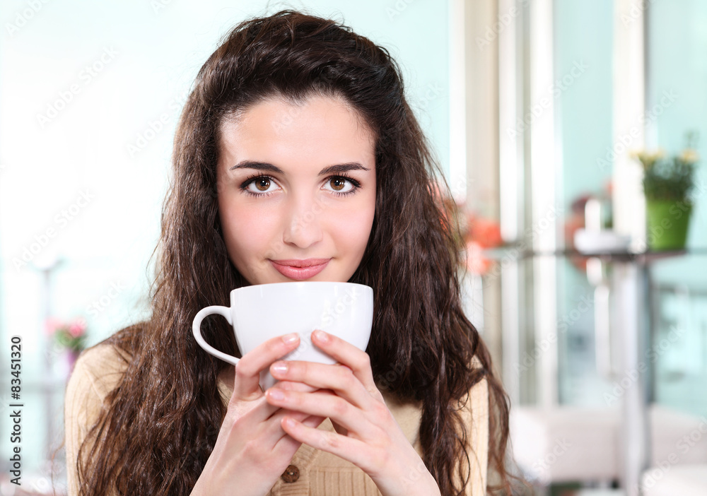 girl smiling in coffee drink with cup in hand girl smiling in coffee drink with cup in hand