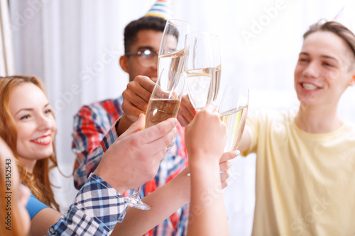 Young people celebrating with champagne 
