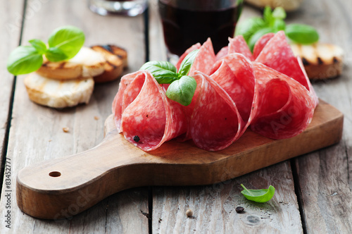 Delicious salami with basil and wine photo