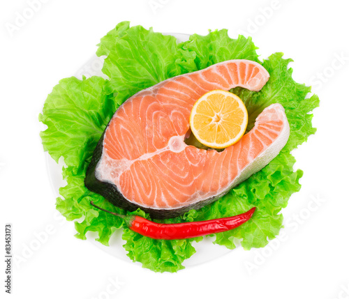 Fresh salmon steak on lettuce.