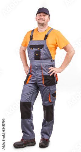 Happy worker wearing overalls. 