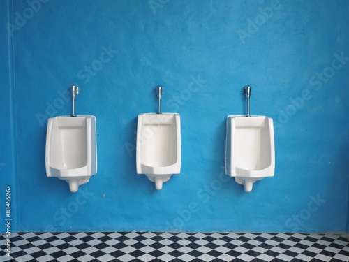  white urinals in men's bathroom photo