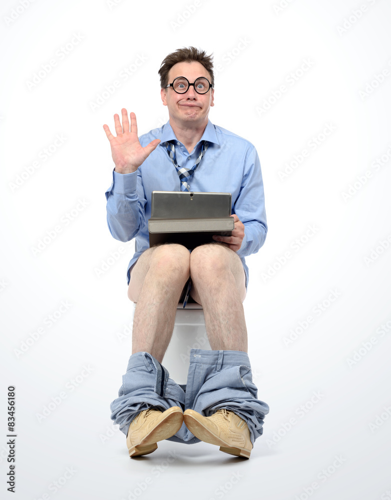 Funny man with tablet pc sitting on the toilet