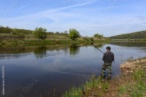 fisherman with a fishing rod on the river