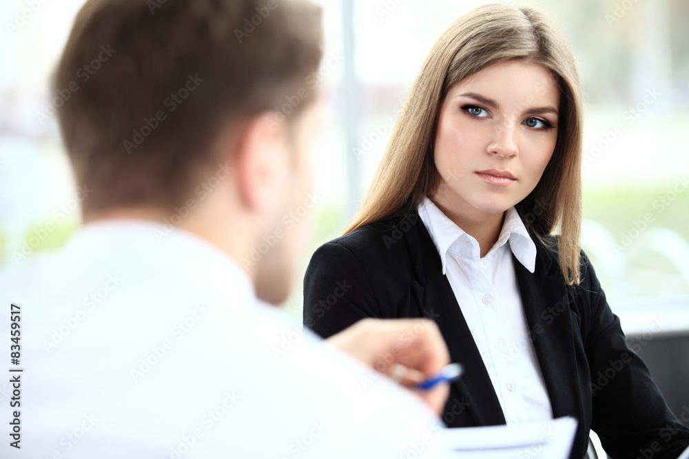 Face of beautiful woman on the background of business people Face of beautiful woman on the background of business people