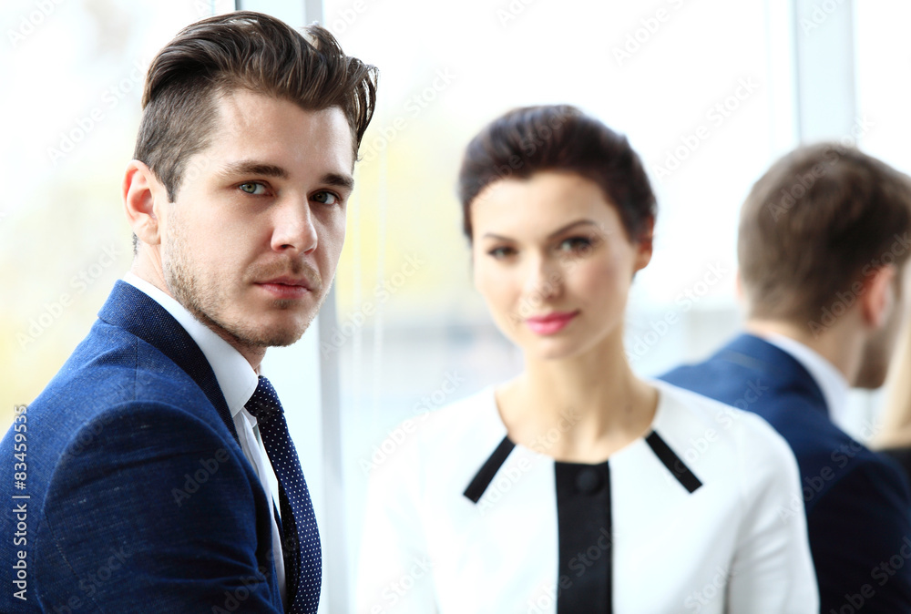 Businessman with colleagues in the background Businessman with colleagues in the background
