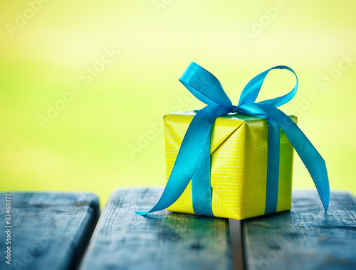 gift box on wooden table on natural sunny background