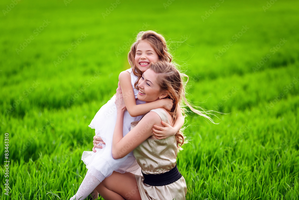 Happy mother and daughter in the meadow Happy mother and daughter in the meadow