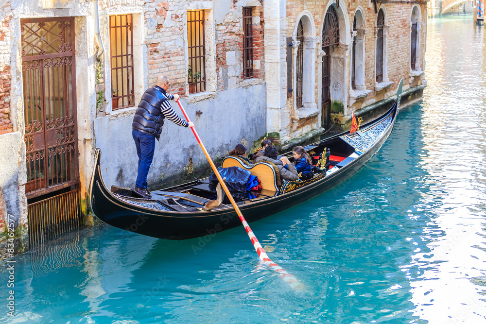 Gondola with tourists. Venice. Italy