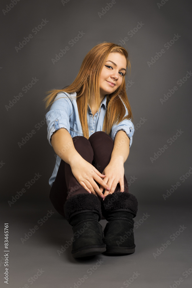 Smiling teenage girl on the floor posing