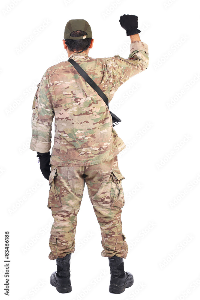 Back view of a soldier with gun holding his arm up
