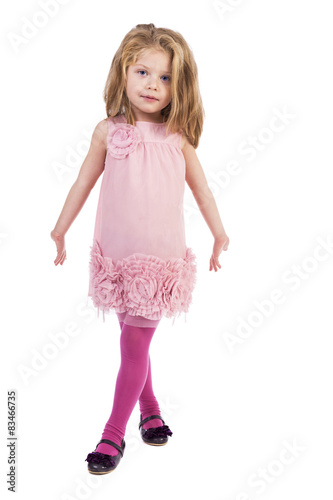 Full length portrait of an adorable liitle girl with pink dress