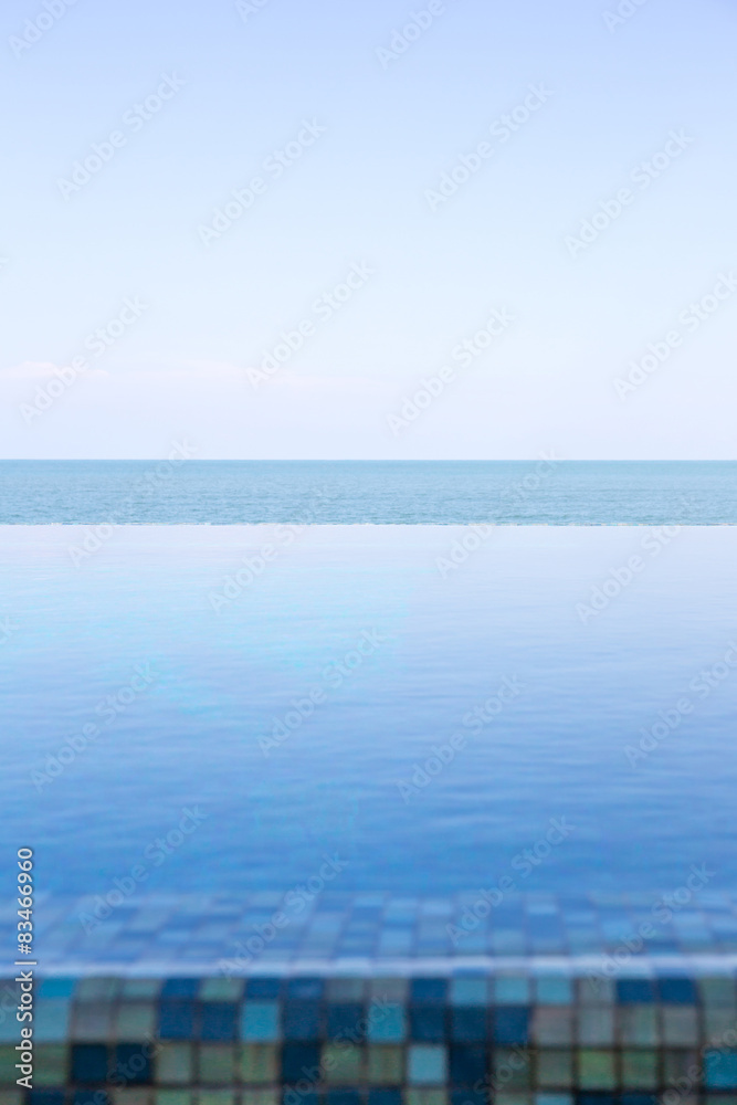 Luxury Infinity swimming pool with blue sky Luxury Infinity swimming pool with blue sky