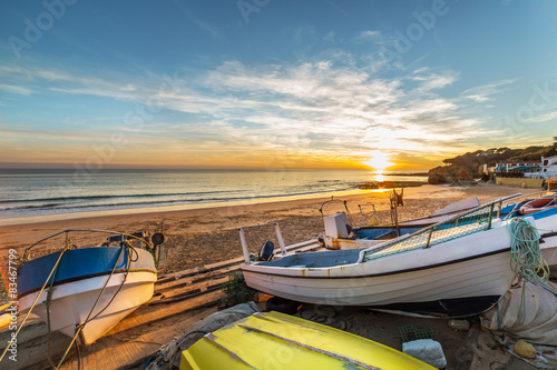 Boats in warm sunset light on the Fisherman's Beach (Praia dos Pescadores) in Albufeira, Portugal