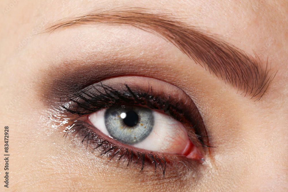 Eye of young woman with tear drop close up Eye of young woman with tear drop close up
