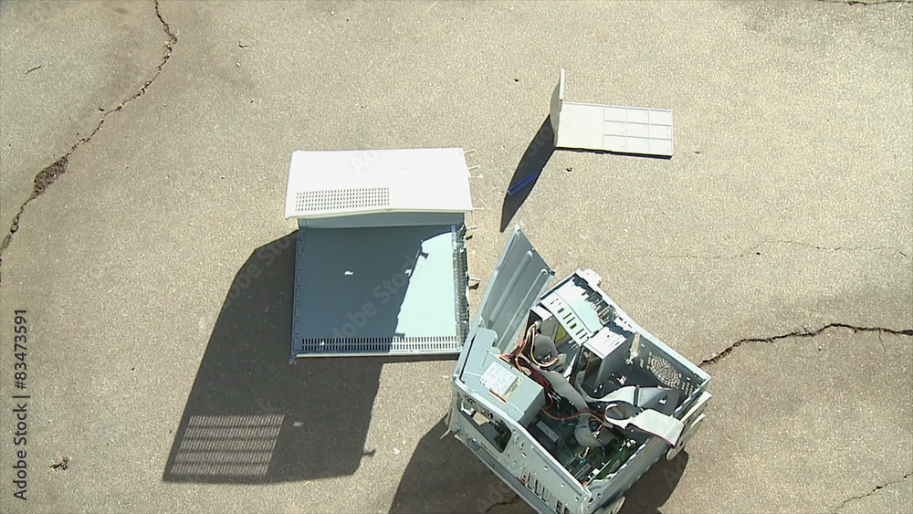 Computer Crash Fail. An old personal computer crashes onto concrete and ...
