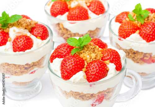 homemade desert with cream chopped cookies and fresh strawberry