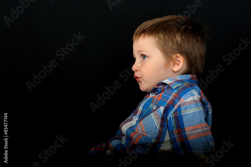 An unusual portrait of a beautiful blond boy photo