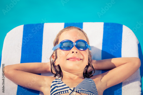 Funny child lying on beach bed