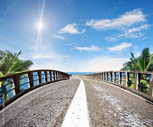 Asphalt road along a tropical sea