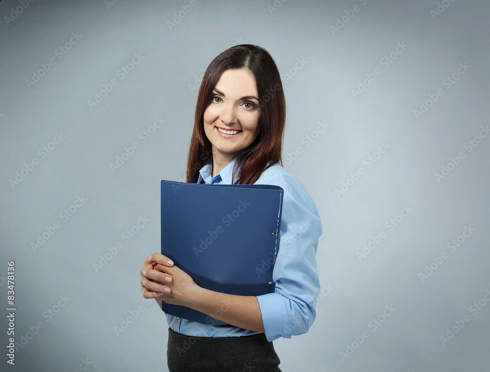 Beautiful middle aged businesswoman on grey background Beautiful middle aged businesswoman on grey background