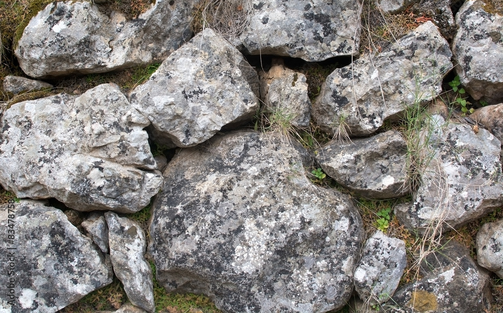 Old rocks in drystone wall outdoors, Majorca, Spain.