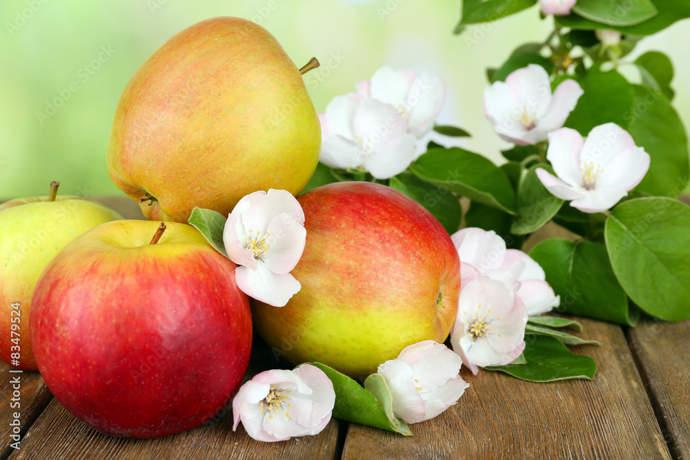 Fresh apples with apple blossom on wooden table, on nature background Fresh apples with apple blossom on wooden table, on nature background