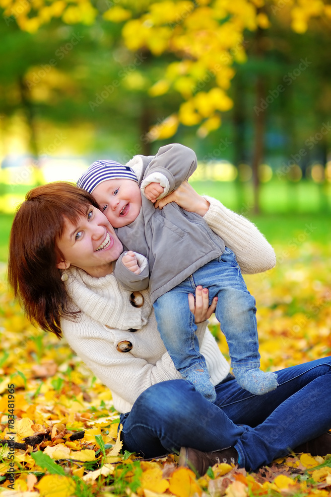 Young mother with her little baby having fun